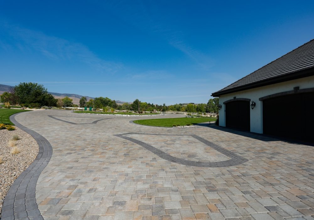 A residential driveway featuring custom interlocking pavers and a contrasting accent border. Landscaping project by Gail Willey Landscaping in Reno, Nevada,Tahoe and California