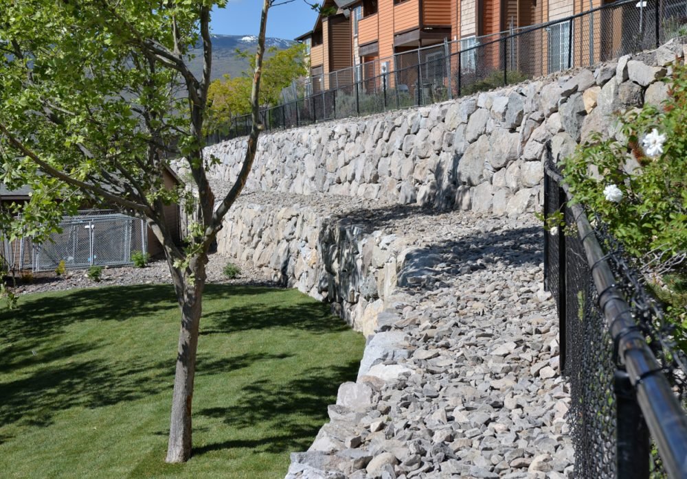 Engineered dry stack boulder retainer walls for commercial or residential properties.