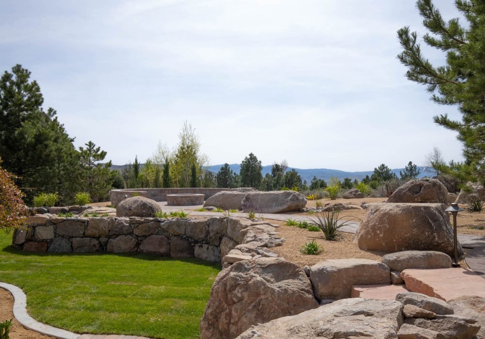Engineered dry stack boulder retainer wall for commercial or residential properties.
