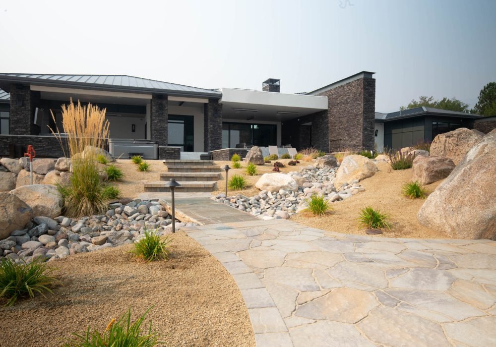 Xeriscape landscaping with pavers, dry creek, boulders and water wise plants