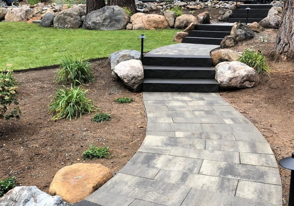 Paver sidewalk and steps with plants and boulders in Reno Nevada.